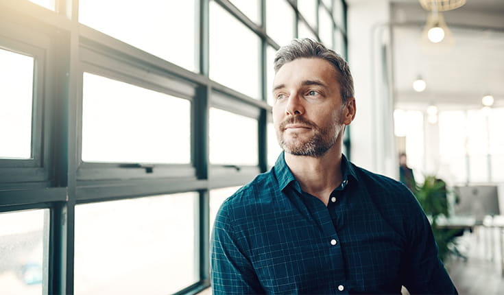 Man Gazing Out Window